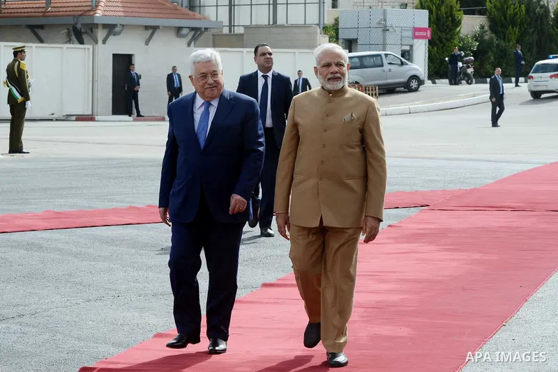 Palestinian President Mahmoud Abbas and India's Prime Minister Narendra Modi review the honor guard during the latter's visit to the Palestinian Authority headquarters in the West Bank city of Ramallah, on February 10, 2...