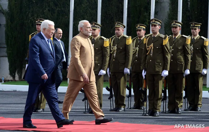 Palestinian President Mahmoud Abbas and India's Prime Minister Narendra Modi review the honor guard during the latter's visit to the Palestinian Authority headquarters in the West Bank city of Ramallah, on February 10, 2...