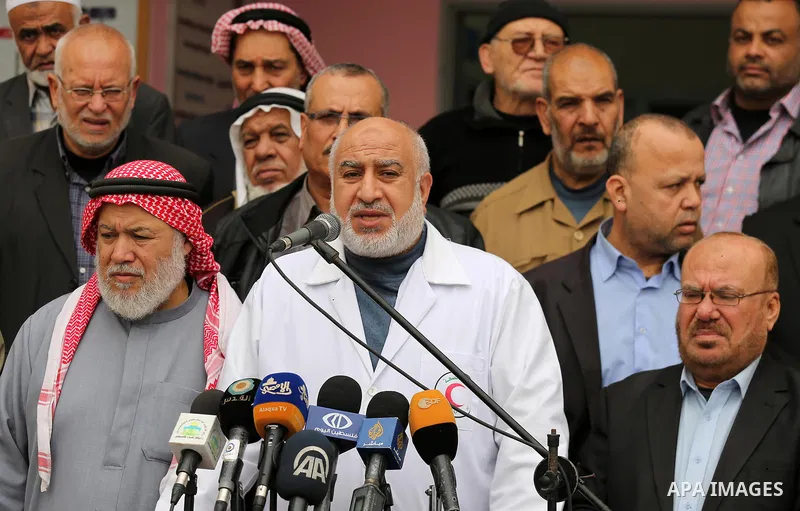 Members of the Palestine Scholars Association attend a press conference outside Durra hospital in Gaza City after it stopped its services on February 11, 2018. Seven medical centers in Gaza have stopped services due to l...