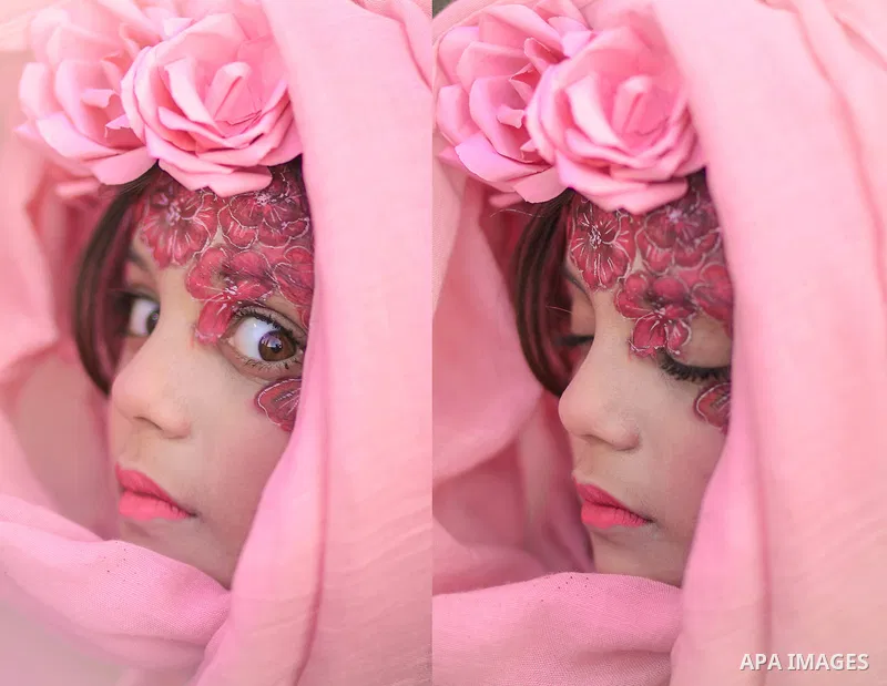 Double cropped portrait of a girl with flowers painted on her face and open eyes, another with closed. Photo by Sanad Ltefa