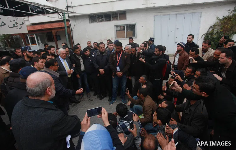 Palestinian Minister of work Mamoun Abu Shahla speaks to graduates during a protest to demand their rights, inside Ministry of Labor headquarters in Gaza city on February 11, 2018. Photo by Mahmoud Ajour