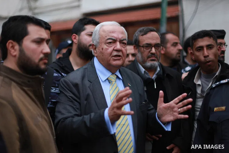 Palestinian Minister of work Mamoun Abu Shahla speaks to graduates during a protest to demand their rights, inside Ministry of Labor headquarters in Gaza city on February 11, 2018. Photo by Mahmoud Ajour