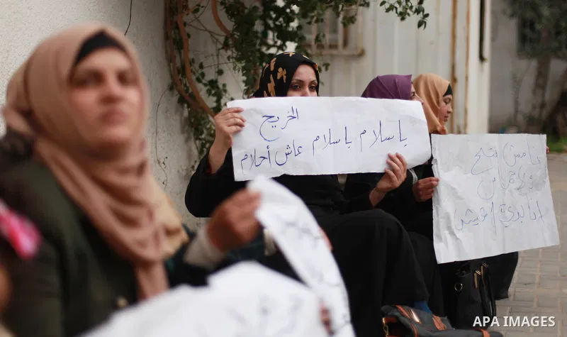 Palestinian graduates hold placards during a protest to demand their rights, inside Ministry of Labor headquarters in Gaza city on February 11, 2018. Photo by Mahmoud Ajour