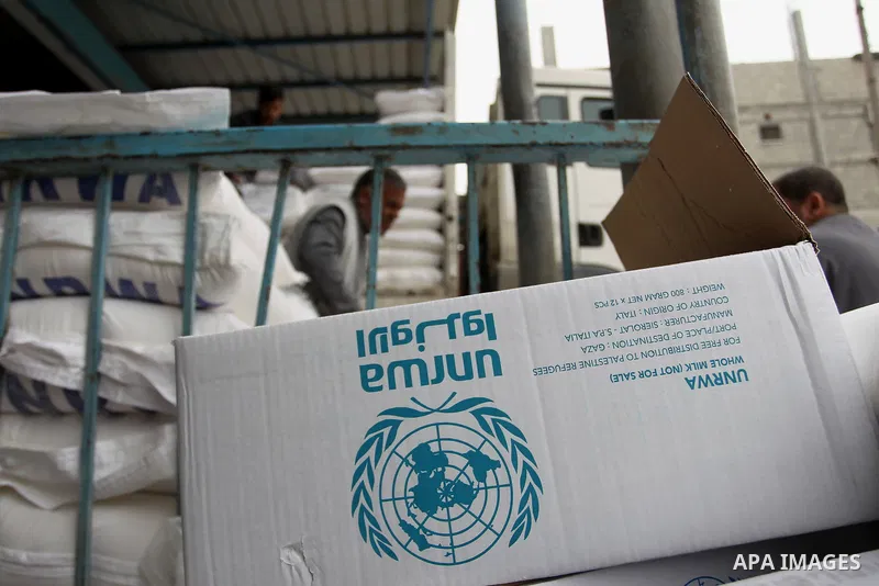 A Palestinian man unloads a sack of flour inside the United Nations' offices after receiving food supplies at the Khan Yunis refugee camp in the southern Gaza Strip on February 11, 2018. On January 16, Washington held ba...