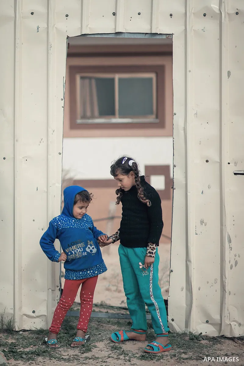 Sisters stand together. Photo by Sanad Ltefa