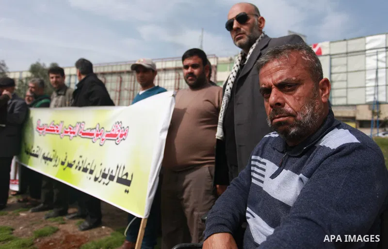 The Palestinian Authority employees in the Gaza Strip take part in a protest demanding their right after Palestinian Authority force them into early retirement in Gaza city on February 12, 2018. Photo by Mahmoud Ajour