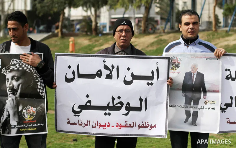 The Palestinian Authority employees in the Gaza Strip take part in a protest demanding their right after Palestinian Authority force them into early retirement in Gaza city on February 12, 2018. Photo by Mahmoud Ajour