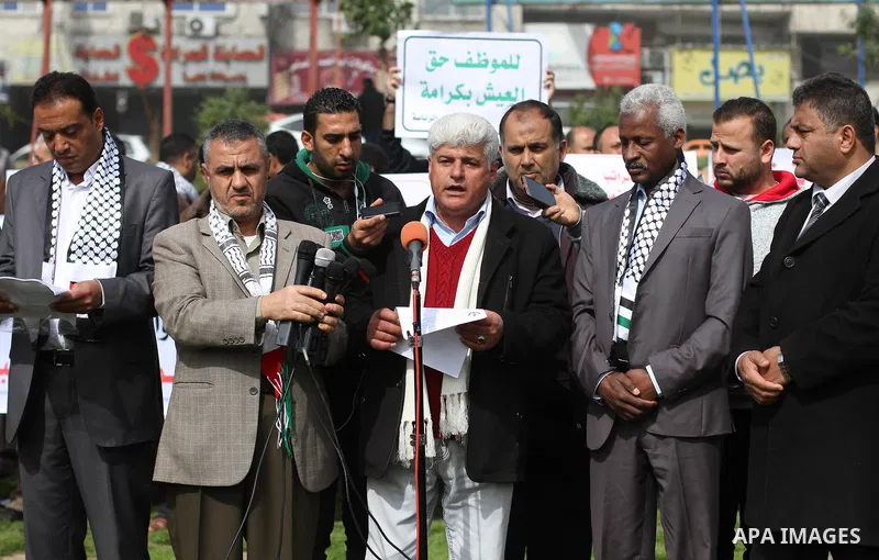 The Palestinian Authority employees in the Gaza Strip take part in a protest demanding their right after Palestinian Authority force them into early retirement in Gaza city on February 12, 2018. Photo by Mahmoud Ajour