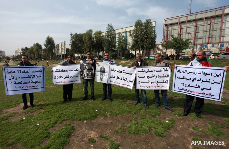 The Palestinian Authority employees in the Gaza Strip take part in a protest demanding their right after Palestinian Authority force them into early retirement in Gaza city on February 12, 2018. Photo by Mahmoud Ajour