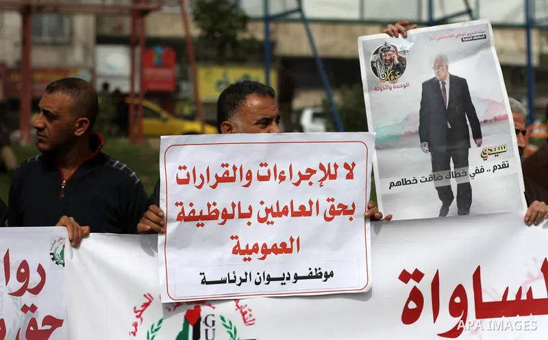 The Palestinian Authority employees in the Gaza Strip take part in a protest demanding their right after Palestinian Authority force them into early retirement in Gaza city on February 12, 2018. Photo by Mahmoud Ajour