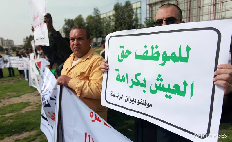 The Palestinian Authority employees in the Gaza Strip take part in a protest demanding their right after Palestinian Authority force them into early retirement in Gaza city on February 12, 2018. Photo by Mahmoud Ajour