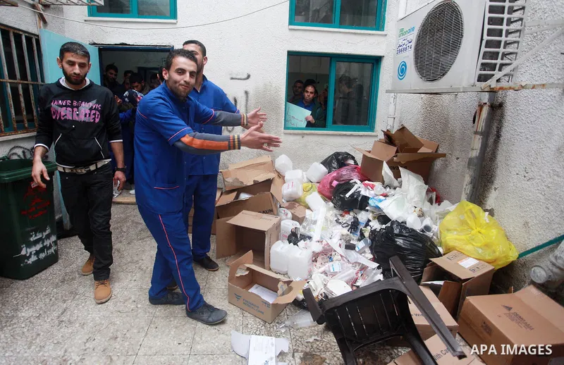 Palestinian cleaners take part in a protest to demand their salaries, at al-Shifa hospital in Gaza City on February 12, 2018. Photo by Mahmoud Ajour