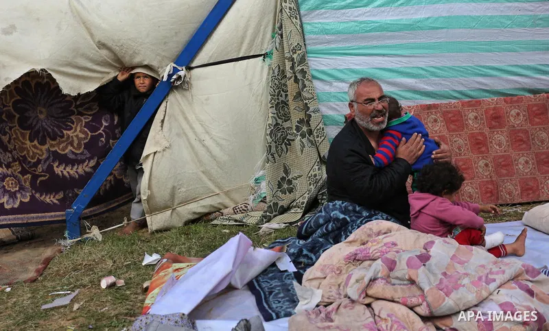 Palestinian Fadel al-Deree and his family gathering around their tent in the middle of Gaza City, on February 13, 2017. The 55-year-old Fadel, his wife and their eight children left their apartment, where they lived for...