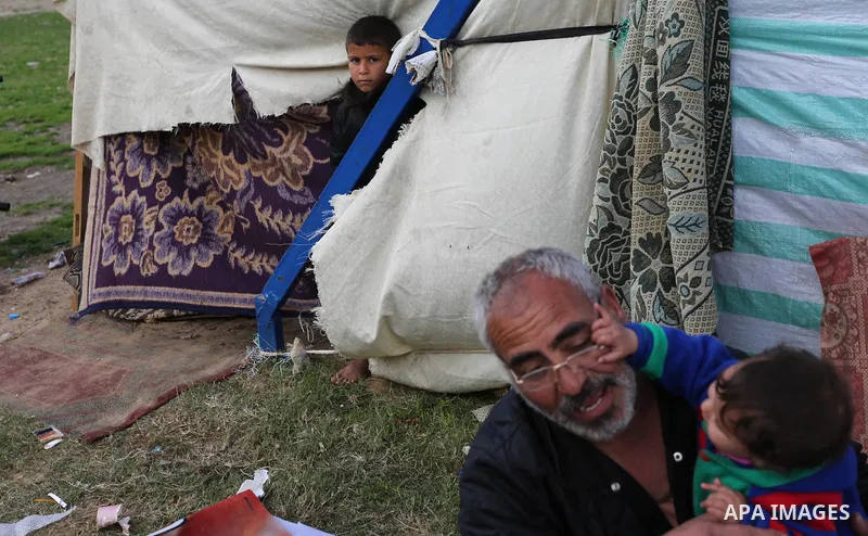 Palestinian Fadel al-Deree and his family gathering around their tent in the middle of Gaza City, on February 13, 2017. The 55-year-old Fadel, his wife and their eight children left their apartment, where they lived for...