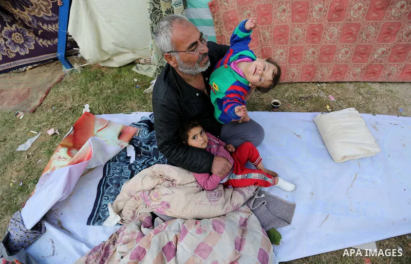Palestinian Fadel al-Deree and his family gathering around their tent in the middle of Gaza City, on February 13, 2017. The 55-year-old Fadel, his wife and their eight children left their apartment, where they lived for...