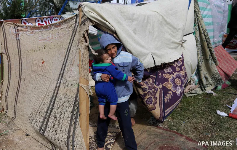 The Palestinian family of Fadel al-Deree gathering around their tent in the middle of Gaza City, on February 13, 2017. The 55-year-old Fadel, his wife and their eight children left their apartment, where they lived for t...