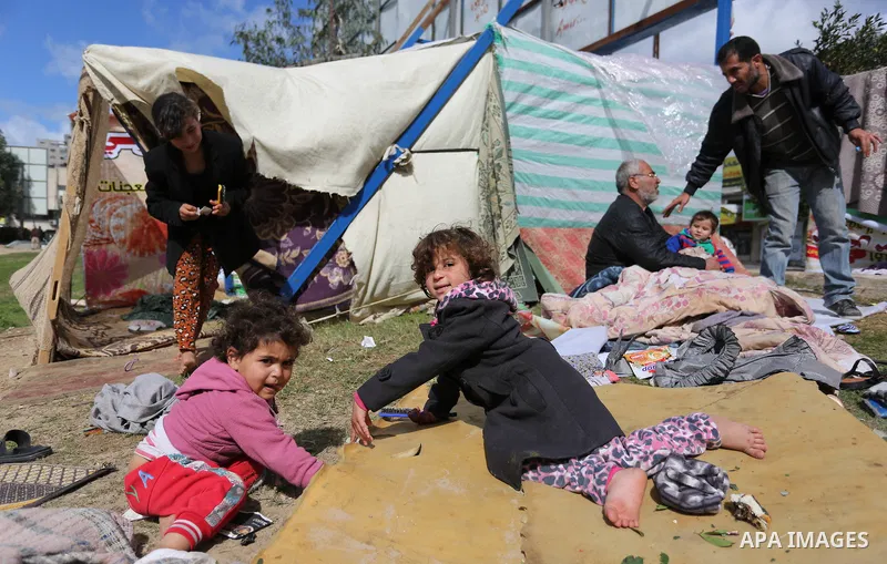 Palestinian Fadel al-Deree and his family gathering around their tent in the middle of Gaza City, on February 13, 2017. The 55-year-old Fadel, his wife and their eight children left their apartment, where they lived for...