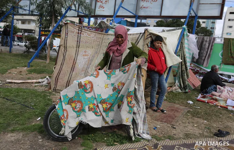 The Palestinian family of Fadel al-Deree gathering around their tent in the middle of Gaza City, on February 13, 2017. The 55-year-old Fadel, his wife and their eight children left their apartment, where they lived for t...