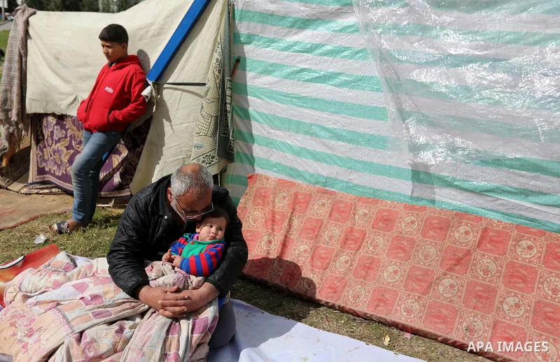 Palestinian Fadel al-Deree and his family gathering around their tent in the middle of Gaza City, on February 13, 2017. The 55-year-old Fadel, his wife and their eight children left their apartment, where they lived for...