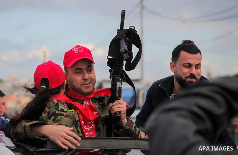 Freed Palestinian prisoner Awad al-Sultan, who served 8 years in an Israeli jail, waves as he holds his daughter upon his release, at Erez crossing, in the northern Gaza Strip, on February 13, 2018. Photo by Ramez Habbou...
