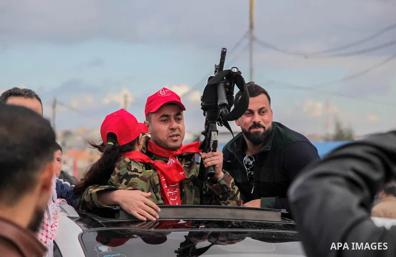 Freed Palestinian prisoner Awad al-Sultan, who served 8 years in an Israeli jail, waves as he holds his daughter upon his release, at Erez crossing, in the northern Gaza Strip, on February 13, 2018. Photo by Ramez Habbou...