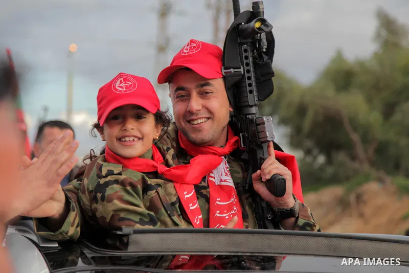 Freed Palestinian prisoner Awad al-Sultan, who served 8 years in an Israeli jail, waves as he holds his daughter upon his release, at Erez crossing, in the northern Gaza Strip, on February 13, 2018. Photo by Ramez Habbou...