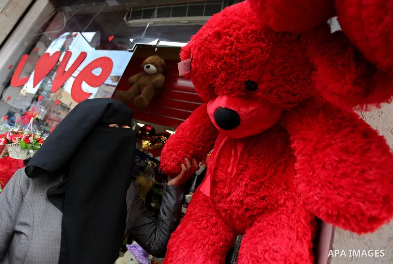 Palestinian vendors display flowers, red teddy bears, red ballons and pillows on Valentine's day in Gaza city on February 14, 2018. Valentine's Day is increasingly popular in the region as people have taken up the custom...