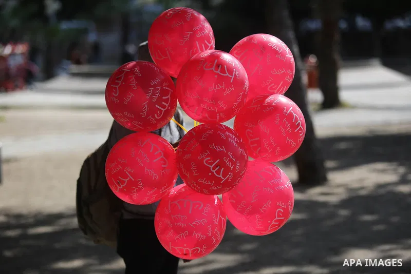 A Palestinian vendor sells red balloons on Valentine's day in Gaza city on February 14, 2018. Valentine's Day is increasingly popular in the region as people have taken up the custom of giving flowers, cards, chocolates...