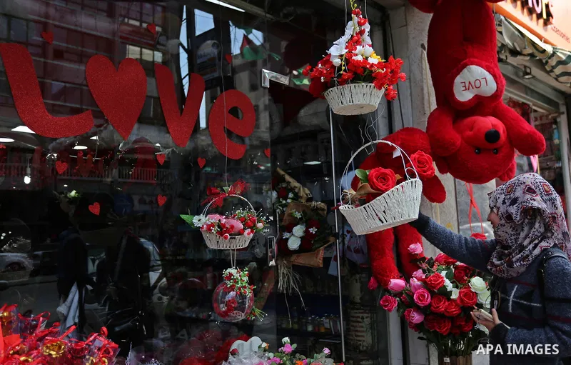 Palestinian vendors display flowers, red teddy bears, red ballons and pillows on Valentine's day in Gaza city on February 14, 2018. Valentine's Day is increasingly popular in the region as people have taken up the custom...