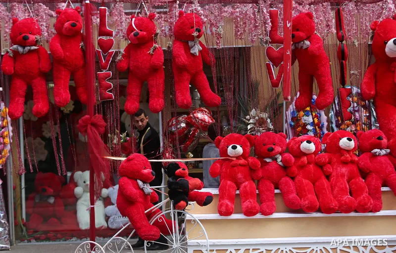 Palestinian vendors display flowers, red teddy bears, red ballons and pillows on Valentine's day in Gaza city on February 14, 2018. Valentine's Day is increasingly popular in the region as people have taken up the custom...