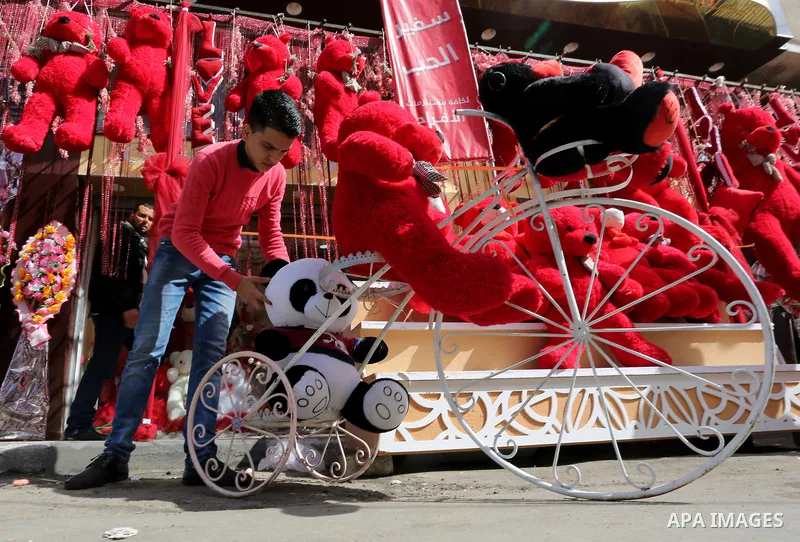 Palestinian vendors display flowers, red teddy bears, red ballons and pillows on Valentine's day in Gaza city on February 14, 2018. Valentine's Day is increasingly popular in the region as people have taken up the custom...