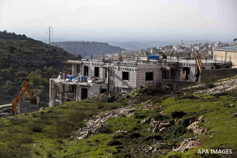 An Israeli machinery demolishes an under-construction Palestinian residential building near Hebron, in the occupied West Bank February 14, 2018. Photo by Wisam Hashlamoun