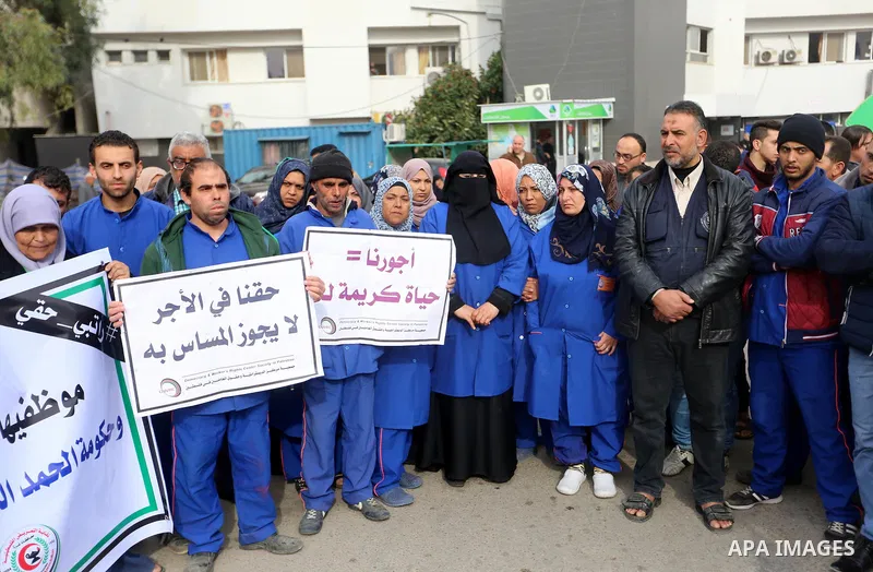 Palestinian employees of the Ministry of Health take part in a protest demanding their rights and against deterioration of health conditions, at al-Shifa hospital in Gaza City on February 15, 2018. Photo by Atia Darwish