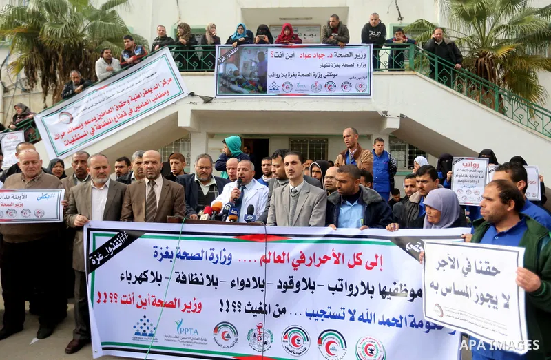 Palestinian employees of the Ministry of Health take part in a protest demanding their rights and against deterioration of health conditions, at al-Shifa hospital in Gaza City on February 15, 2018. Photo by Atia Darwish