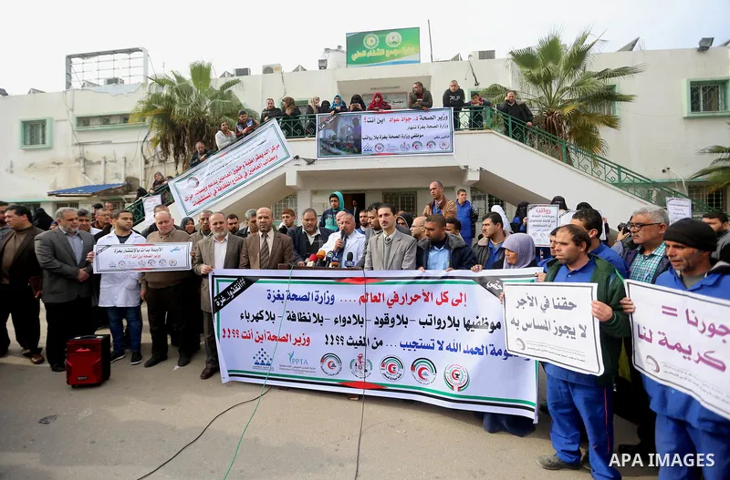 Palestinian employees of the Ministry of Health take part in a protest demanding their rights and against deterioration of health conditions, at al-Shifa hospital in Gaza City on February 15, 2018. Photo by Atia Darwish