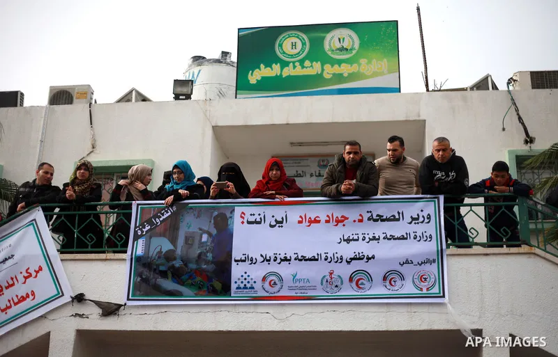 Palestinian employees of the Ministry of Health take part in a protest demanding their rights and against deterioration of health conditions, at al-Shifa hospital in Gaza City on February 15, 2018. Photo by Mahmoud Ajour