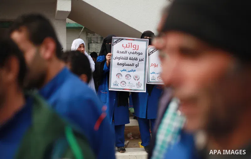 Palestinian employees of the Ministry of Health take part in a protest demanding their rights and against deterioration of health conditions, at al-Shifa hospital in Gaza City on February 15, 2018. Photo by Mahmoud Ajour