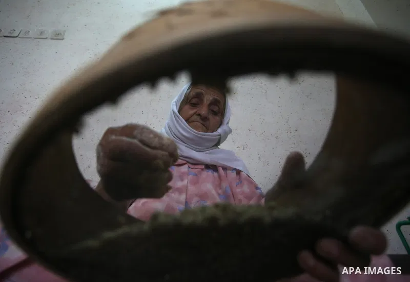 A Palestinian woman prepares fresh couscous, in the West Bank city of Nablus on February 15, 2018. Virgin Atlantic, a British airline has removed the word “Palestinian” from the name of a couscous grain salad on its in-f...