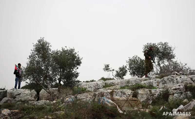Israeli soldier fires tear gas grenades at Palestinians during clashes at the Beta village near the West Bank city of Nablus, 15 February 2018. According to local sources at least five Palestinian were injured during the...