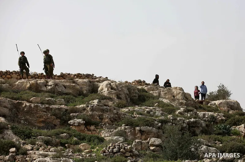 Israeli security forces take position during clashes with Palestinian protesters in the occupied West Bank village of Baita, just outside of Nablus, on February 16, 2018. Photo by Shadi Jarar'ah