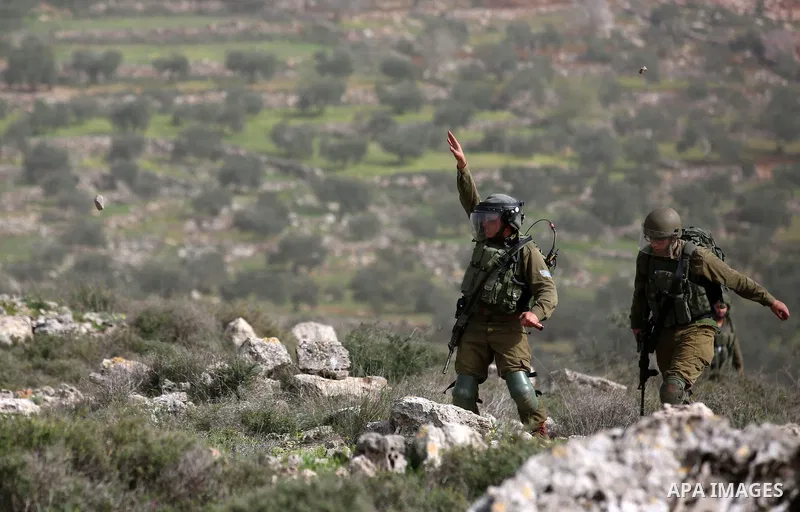 Israeli security forces take position during clashes with Palestinian protesters in the occupied West Bank village of Baita, just outside of Nablus, on February 16, 2018. Photo by Shadi Jarar'ah