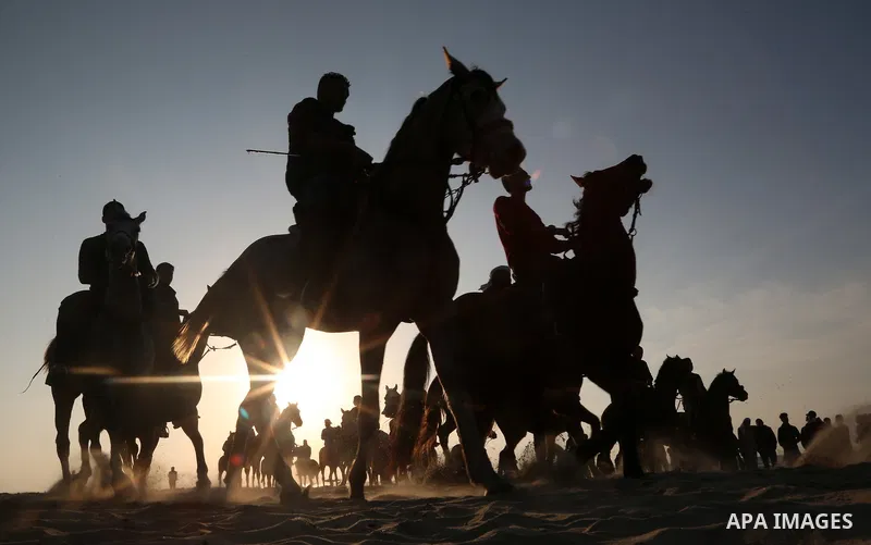 Palestinian men ride horses during a local racing on the beach of Gaza city on February 16, 2018. Photo by Ashraf Amra