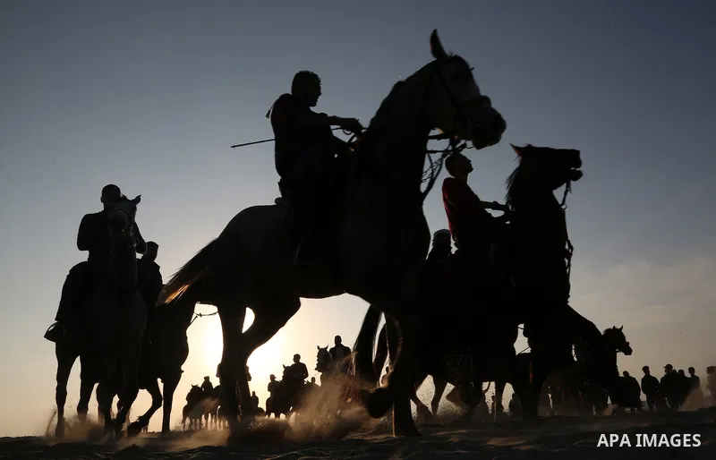 Palestinian men ride horses during a local racing on the beach of Gaza city on February 16, 2018. Photo by Ashraf Amra