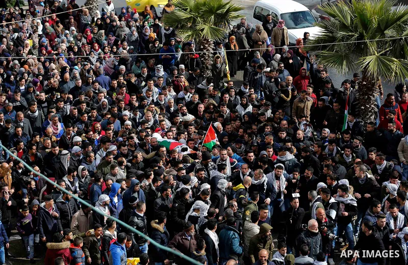 Mourners carry the body of Palestinian Hamza Zamareh during his funeral in Halhoul, in the West Bank city of Hebron on February 17, 2018. Hamza stabbed a security guard at the entrance of the Israeli settlement Karmei Tz...