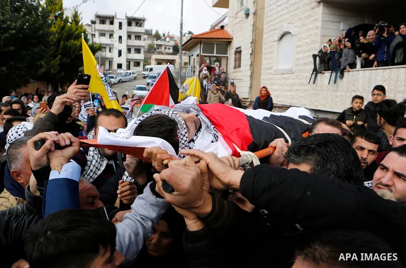 Mourners carry the body of Palestinian Hamza Zamareh during his funeral in Halhoul, in the West Bank city of Hebron on February 17, 2018. Hamza stabbed a security guard at the entrance of the Israeli settlement Karmei Tz...