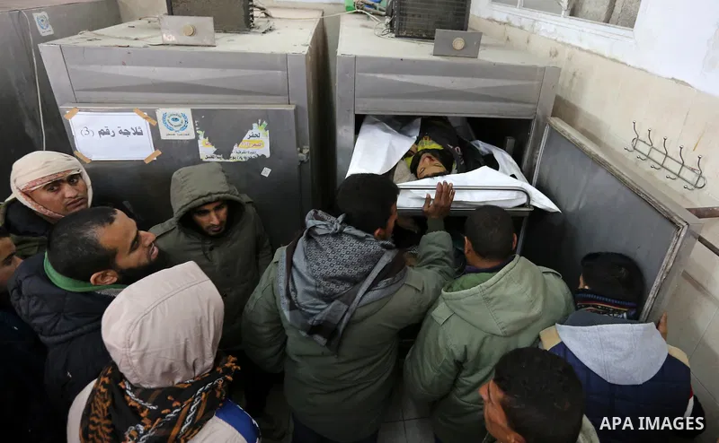 The relatives of two Palestinians killed in an Israeli air strike, bid them farewell at a morgue of a hospital in Rafah in the southern Gaza Strip on late February 18, 2018. Two Palestinians were killed by Israeli fire,...
