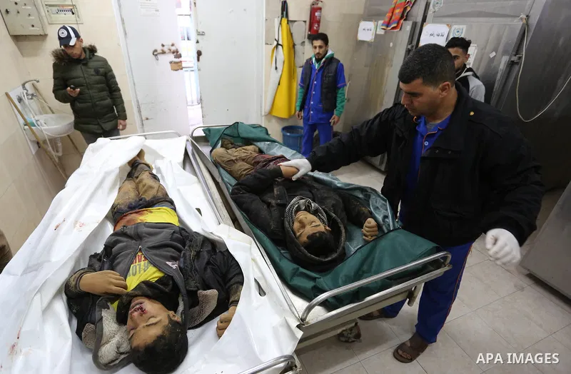 The relatives of two Palestinians killed in an Israeli air strike, bid them farewell at a morgue of a hospital in Rafah in the southern Gaza Strip on late February 18, 2018. Two Palestinians were killed by Israeli fire,...