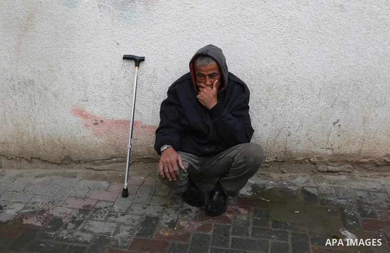 A Palestinian man mourns outside a morgue of a hospital in Rafah in the southern Gaza Strip on late February 18, 2018. Two Palestinians were killed by Israeli fire, Gaza medical sources said, after four soldiers were wou...