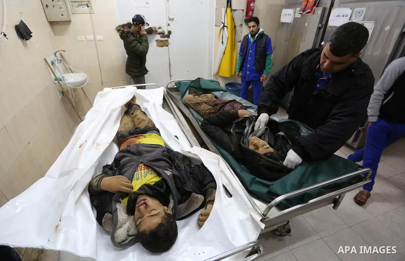 The relatives of two Palestinians killed in an Israeli air strike, bid them farewell at a morgue of a hospital in Rafah in the southern Gaza Strip on late February 18, 2018. Two Palestinians were killed by Israeli fire,...