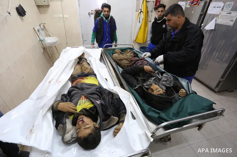 The relatives of two Palestinians killed in an Israeli air strike, bid them farewell at a morgue of a hospital in Rafah in the southern Gaza Strip on late February 18, 2018. Two Palestinians were killed by Israeli fire,...